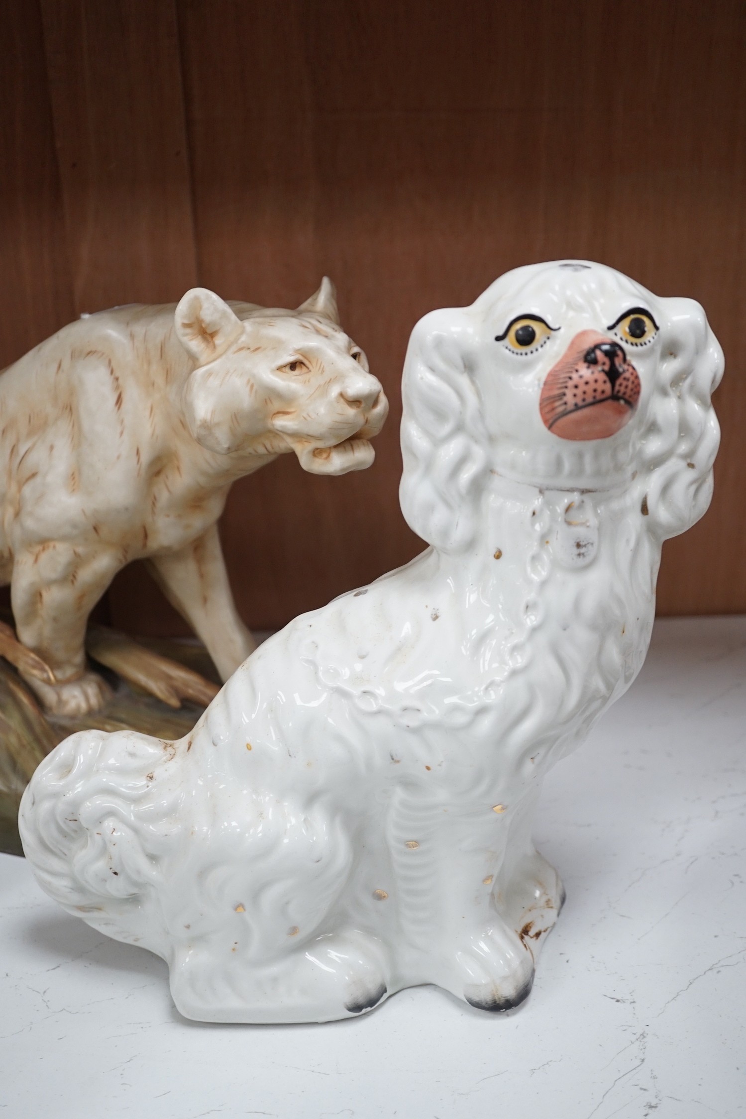 A Royal Dux tiger, a pair of Staffordshire Spaniels and a figural flat back, tiger 28cms high